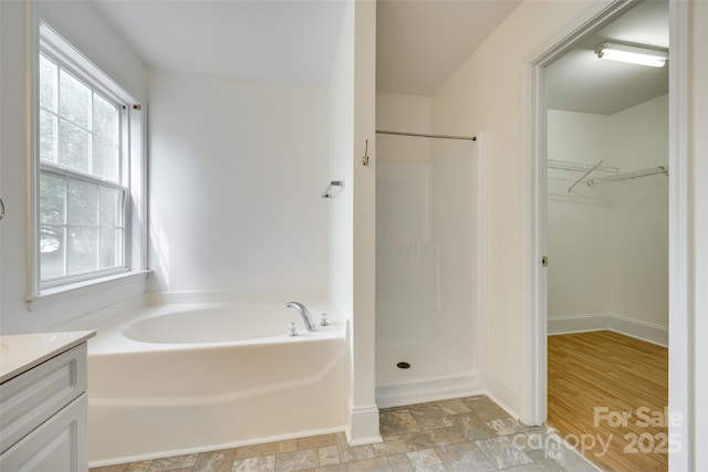 1835 Montague Rd, Clover, SC 29710 - full bath featuring vanity, a bath, a walk in closet, a shower, and stone finish flooring