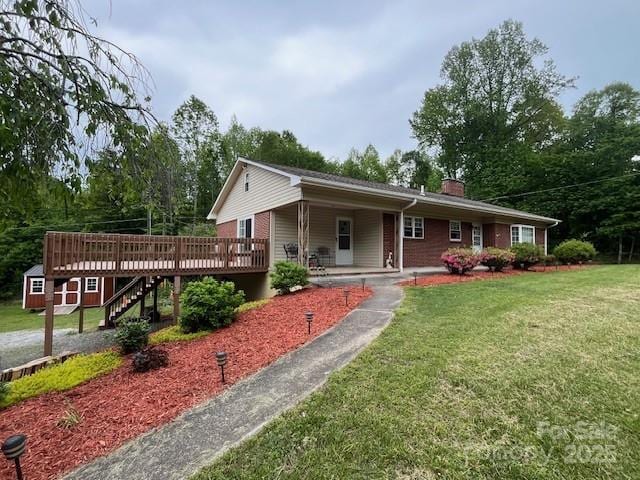 323 Hibriten Dr SE, Lenoir, NC 28645 - ranch-style house with a deck, a chimney, an outbuilding, and a front lawn