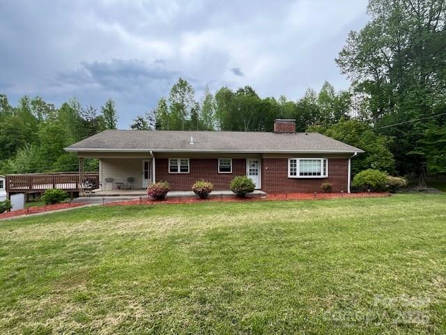 323 Hibriten Dr SE, Lenoir, NC 28645 - back of property with a lawn and a chimney
