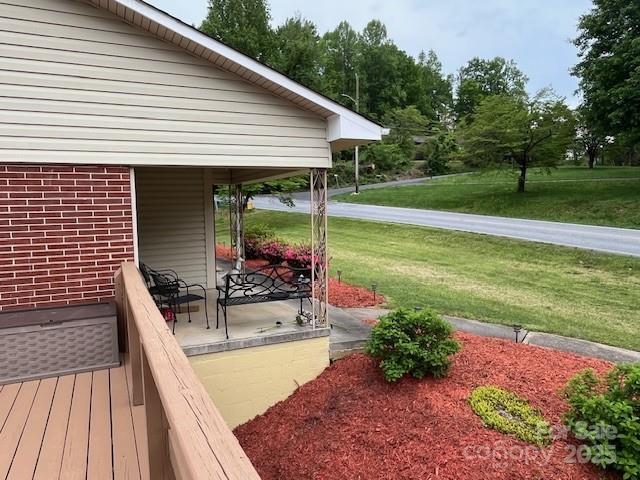 323 Hibriten Dr SE, Lenoir, NC 28645 - wooden deck featuring a lawn and covered porch