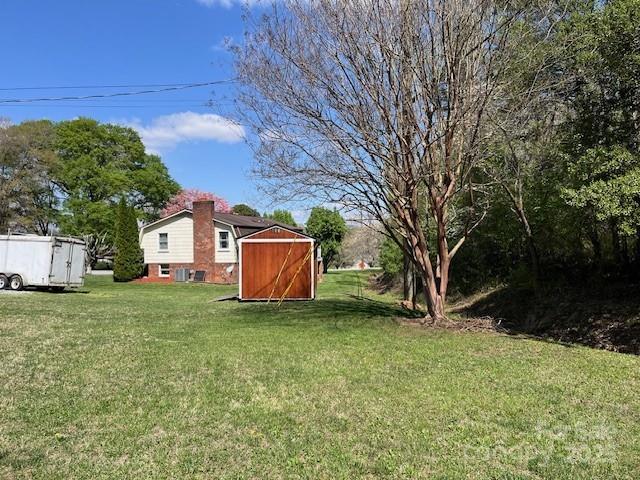323 Hibriten Dr SE, Lenoir, NC 28645 - view of yard featuring a shed and an outbuilding