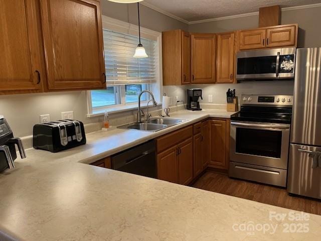 323 Hibriten Dr SE, Lenoir, NC 28645 - kitchen featuring brown cabinetry, crown molding, light countertops, a sink, and stainless steel appliances
