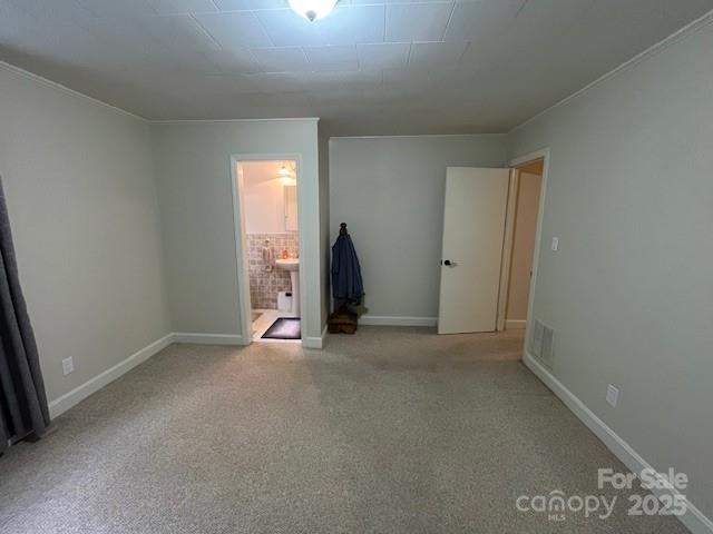 323 Hibriten Dr SE, Lenoir, NC 28645 - unfurnished bedroom with baseboards, carpet, and ensuite bathroom