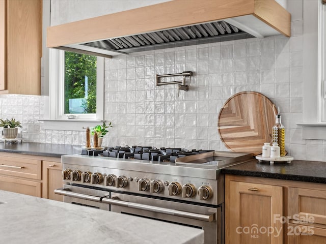 8044 Edgewater Dr Unit 100, Norwood, NC 28128 - kitchen featuring custom range hood, tasteful backsplash, double oven range, and dark stone counters