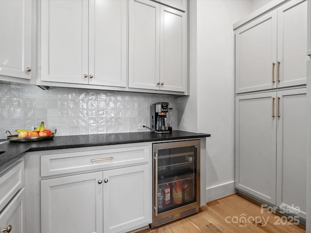 8044 Edgewater Dr Unit 100, Norwood, NC 28128 - indoor dry bar with wine cooler, light wood-style floors, and decorative backsplash