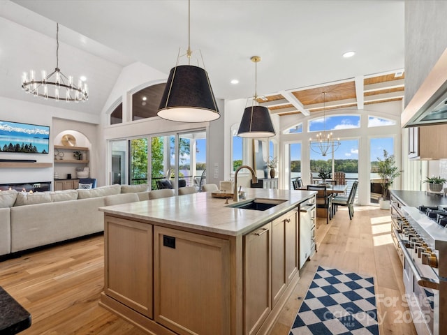 8044 Edgewater Dr Unit 100, Norwood, NC 28128 - kitchen featuring a chandelier, a sink, double oven range, light wood-style flooring, and high vaulted ceiling