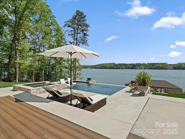 8044 Edgewater Dr Unit 100, Norwood, NC 28128 - view of swimming pool featuring a water view and a pool with connected hot tub