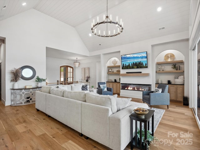 8044 Edgewater Dr Unit 100, Norwood, NC 28128 - living area with a chandelier, built in shelves, light wood finished floors, a glass covered fireplace, and recessed lighting