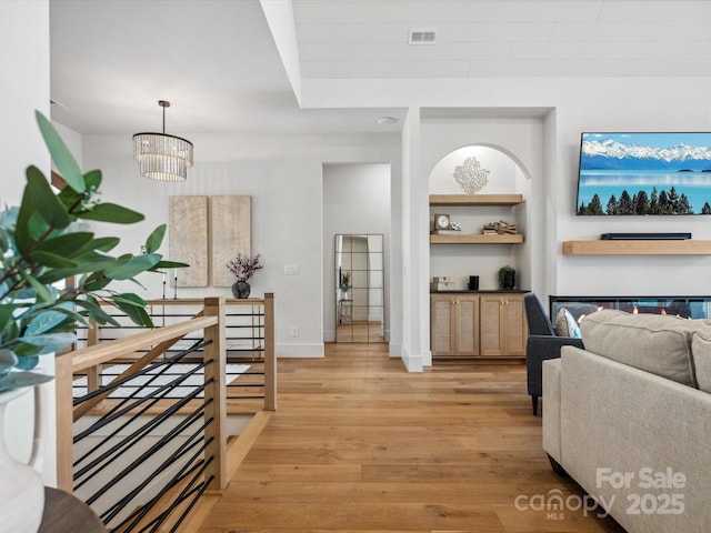 8044 Edgewater Dr Unit 100, Norwood, NC 28128 - interior space featuring an upstairs landing, light wood-style floors, a chandelier, and baseboards