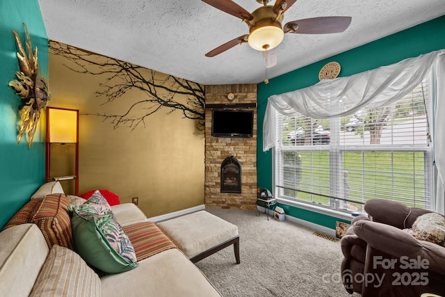 166 Kennedy Rd, Weaverville, NC 28787 - carpeted living room featuring a textured ceiling, a ceiling fan, a fireplace, and baseboards