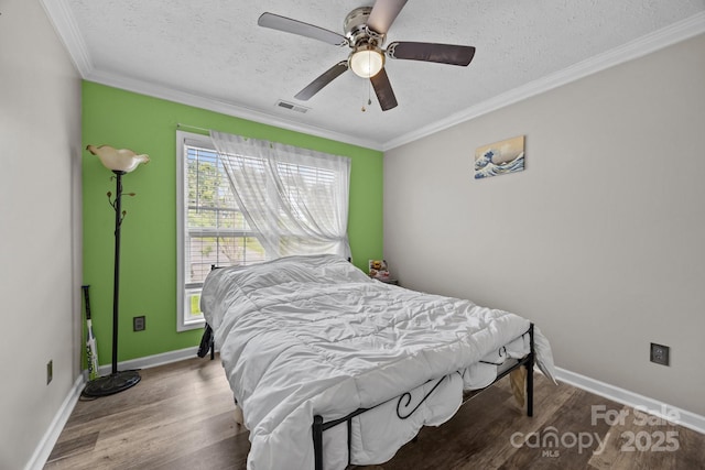 166 Kennedy Rd, Weaverville, NC 28787 - bedroom featuring a textured ceiling, crown molding, wood finished floors, baseboards, and a ceiling fan