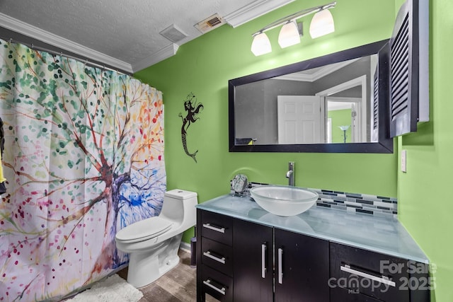 166 Kennedy Rd, Weaverville, NC 28787 - full bathroom with wood finished floors, vanity, toilet, crown molding, and backsplash