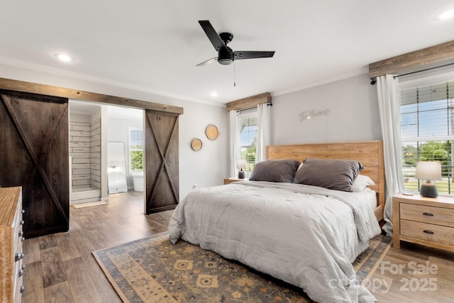 bedroom with crown molding, multiple windows, and light wood-style floors
