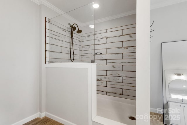full bathroom with crown molding, a walk in shower, baseboards, and wood finished floors
