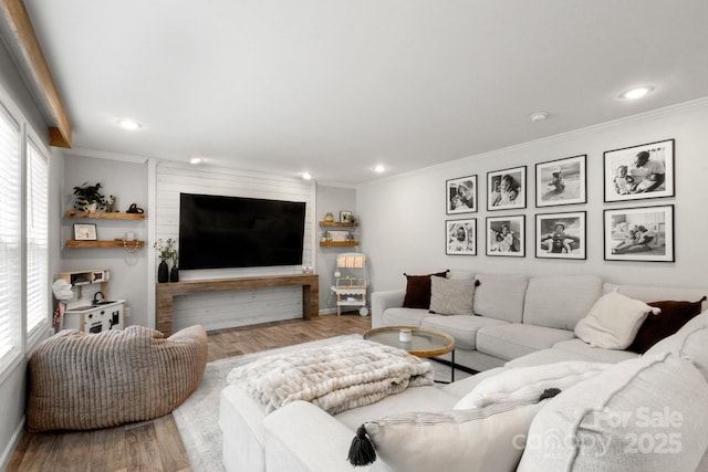 living area with crown molding, recessed lighting, plenty of natural light, and wood finished floors
