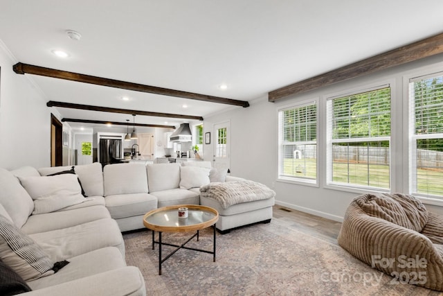 living room featuring plenty of natural light, recessed lighting, and light wood-style flooring