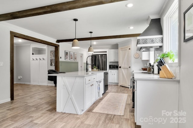 kitchen with light wood-style floors, stainless steel appliances, white cabinetry, beamed ceiling, and custom exhaust hood