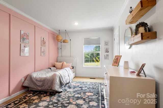 bedroom with crown molding, baseboards, and light carpet