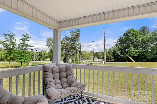 wooden terrace featuring a yard