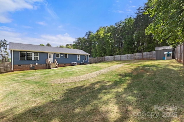 exterior space featuring an outbuilding, a fenced backyard, and a storage shed