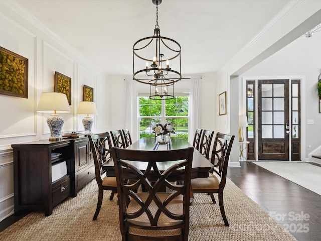 5420 Meadowcroft Way, Fort Mill, SC 29708 - dining room featuring a chandelier, wood finished floors, a decorative wall, and ornamental molding