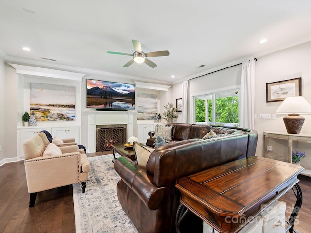 5420 Meadowcroft Way, Fort Mill, SC 29708 - living area with a ceiling fan, dark wood-type flooring, crown molding, a warm lit fireplace, and recessed lighting