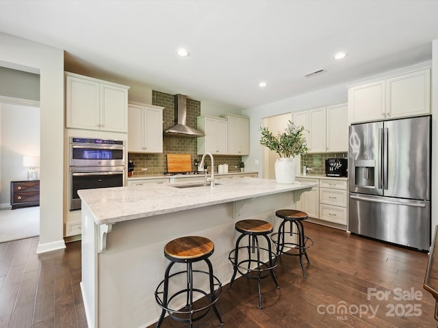 5420 Meadowcroft Way, Fort Mill, SC 29708 - kitchen with appliances with stainless steel finishes, wall chimney range hood, a sink, decorative backsplash, and a center island with sink