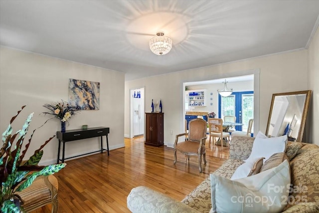 324 Autumn Dr, Harrisburg, NC 28075 - living area with an inviting chandelier, wood finished floors, and baseboards