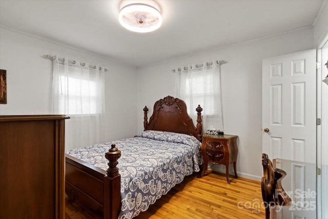 324 Autumn Dr, Harrisburg, NC 28075 - bedroom featuring baseboards, light wood-type flooring, ornamental molding, and multiple windows