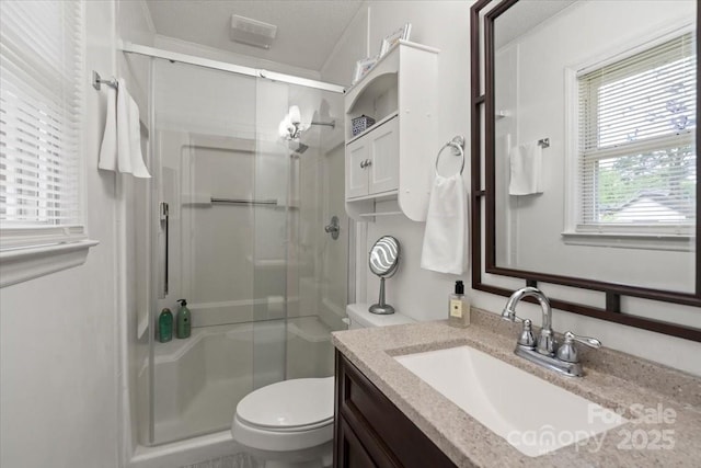 324 Autumn Dr, Harrisburg, NC 28075 - bathroom with toilet, visible vents, vanity, and a stall shower