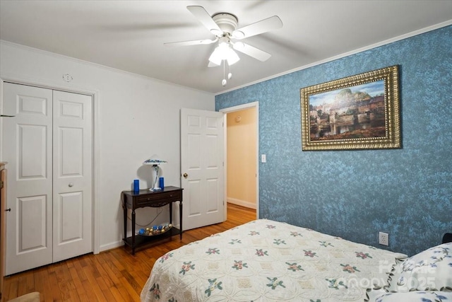 324 Autumn Dr, Harrisburg, NC 28075 - bedroom with wood finished floors, ornamental molding, wallpapered walls, and a closet