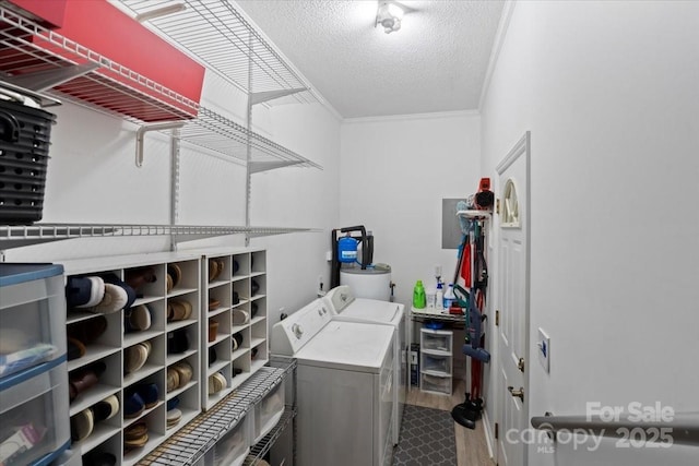 324 Autumn Dr, Harrisburg, NC 28075 - clothes washing area featuring a textured ceiling, washer and clothes dryer, ornamental molding, and laundry area