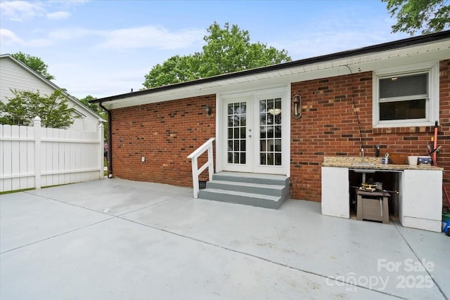 324 Autumn Dr, Harrisburg, NC 28075 - view of patio with entry steps, french doors, and fence