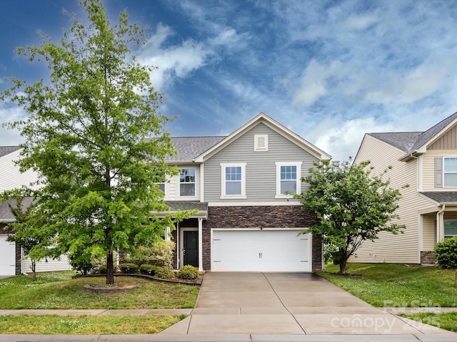 view of front of home with a garage, a front lawn, driveway, and stone siding