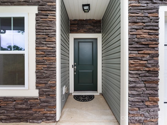 view of exterior entry with stone siding