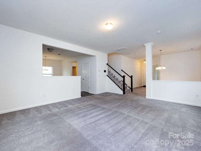 unfurnished living room featuring stairway, baseboards, a notable chandelier, and carpet floors