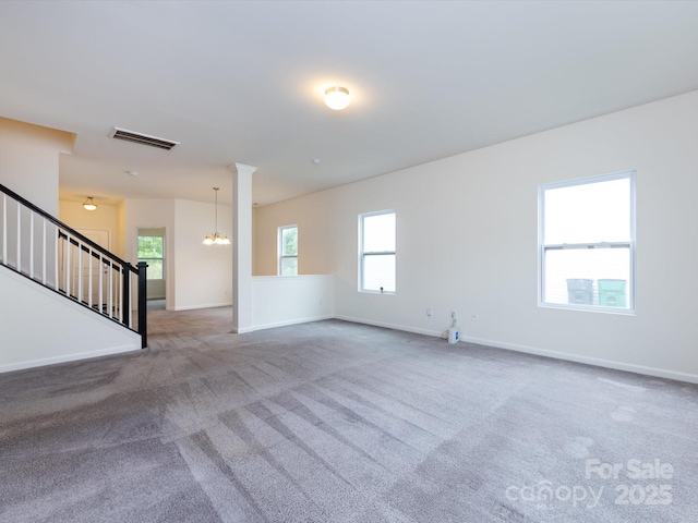 unfurnished living room with stairway, carpet flooring, baseboards, visible vents, and a notable chandelier