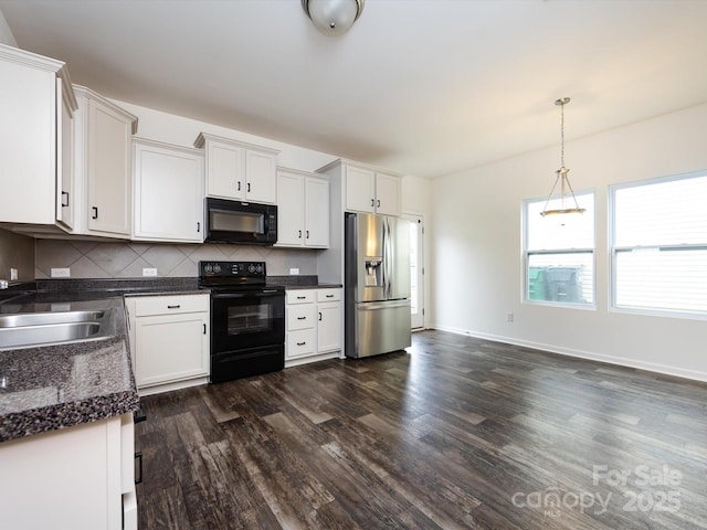 kitchen with tasteful backsplash, a sink, dark countertops, black appliances, and dark wood-style flooring