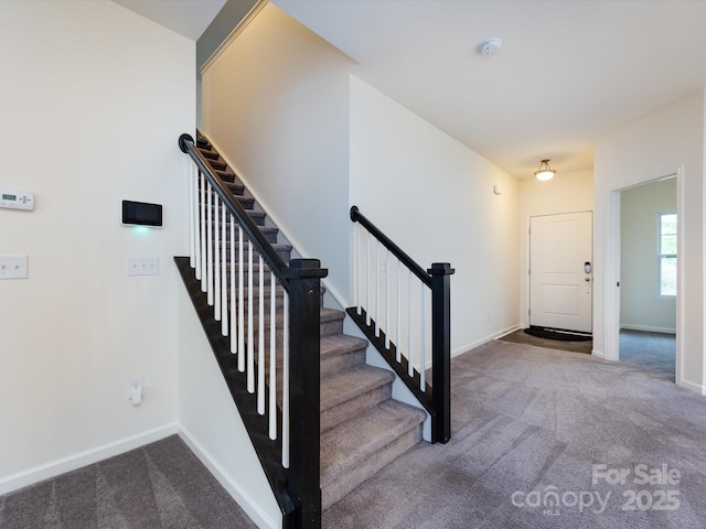 stairs with baseboards and carpet floors