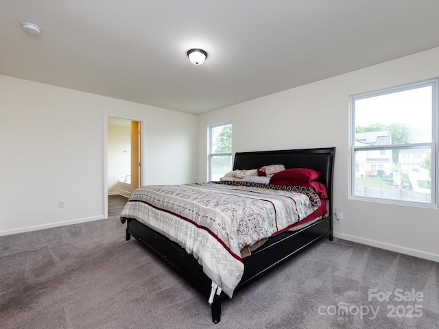 carpeted bedroom featuring baseboards