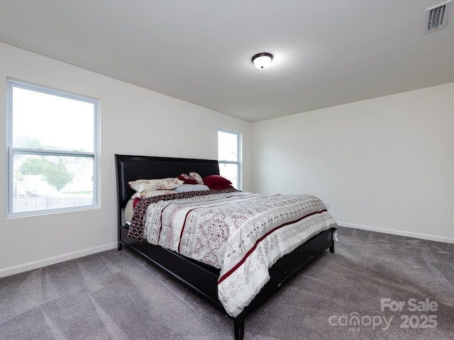 carpeted bedroom with visible vents and baseboards