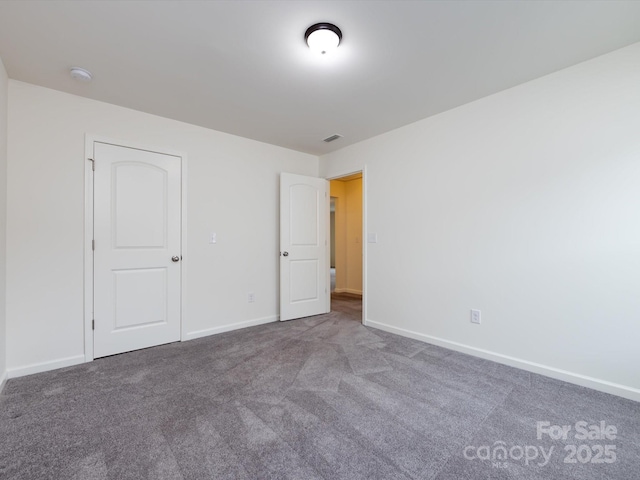 unfurnished bedroom featuring visible vents, carpet, and baseboards