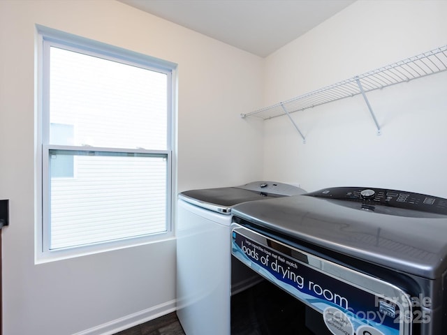 washroom with separate washer and dryer, baseboards, laundry area, and plenty of natural light