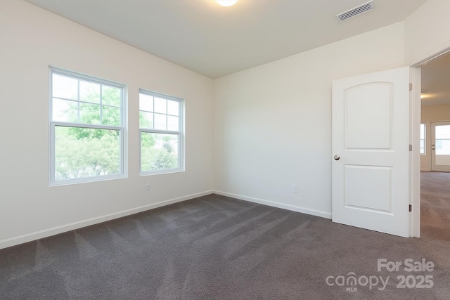 1523 Loropetalum Rd, Charlotte, NC 28215 - unfurnished room featuring baseboards, dark carpet, and visible vents