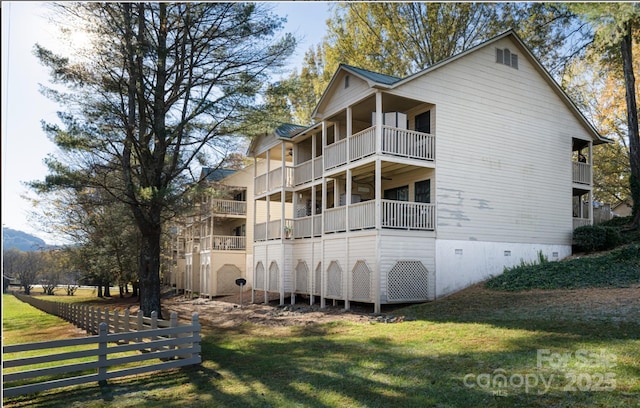 160 Whitney Blvd, Lake Lure, NC 28746 - back of house featuring a balcony, fence, a yard, and crawl space
