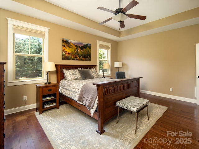 bedroom with baseboards, ceiling fan, and hardwood / wood-style floors