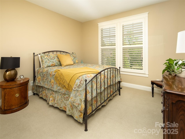 bedroom with carpet floors and baseboards