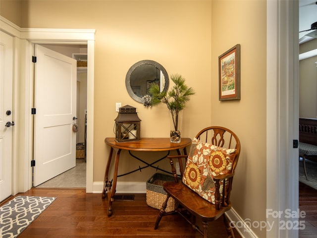 interior space with baseboards and wood finished floors