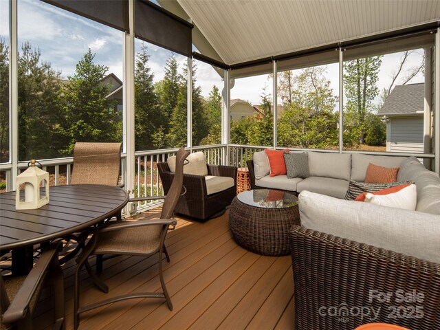 sunroom featuring outdoor lounge area and outdoor dining space