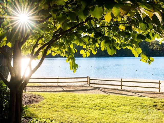 property view of water featuring fence
